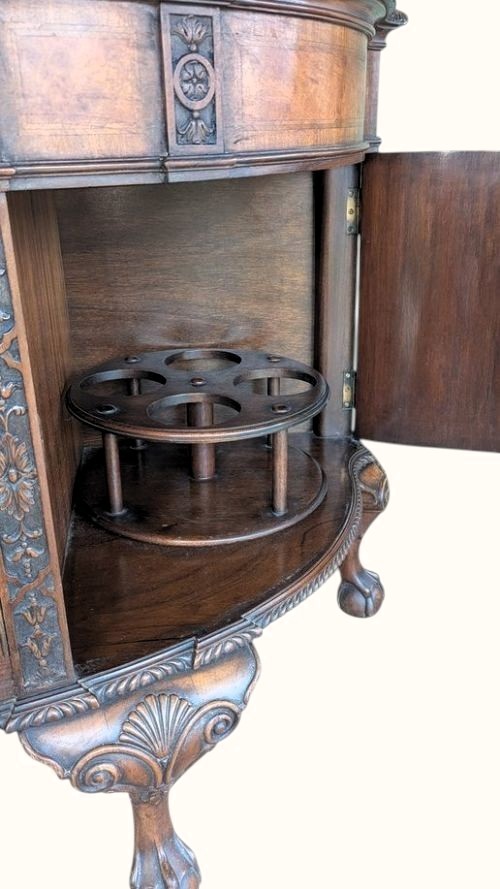 A semicircular burr walnut demi-lune sideboard featuring carved cabriole legs with ball-and-claw feet and decorative foliage carvings on the upright pilasters. View XIII
