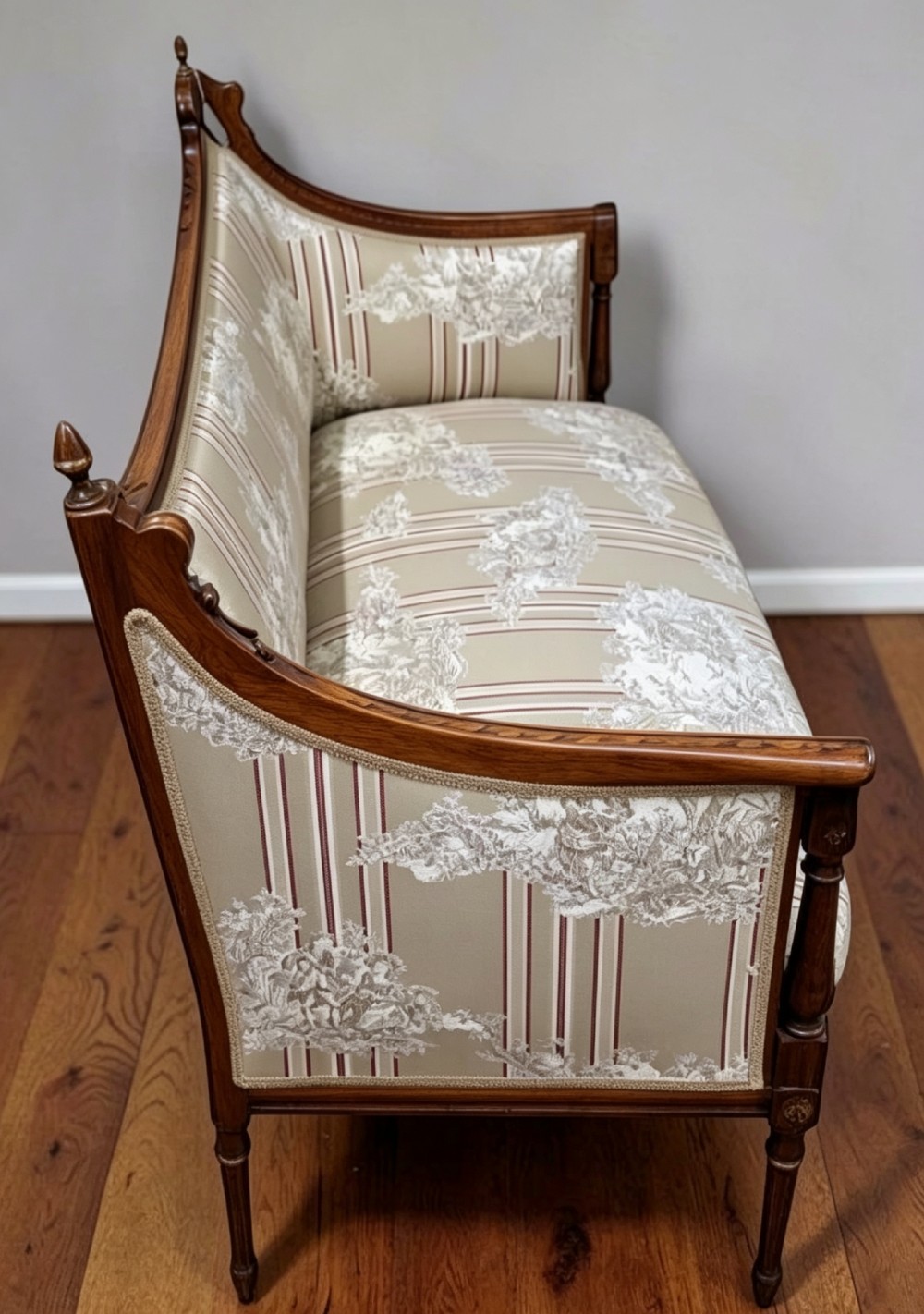 An Edwardian walnut drawing room sofa with a curved backrest, turned finials, slender turned legs, and beige striped floral upholstery. View III