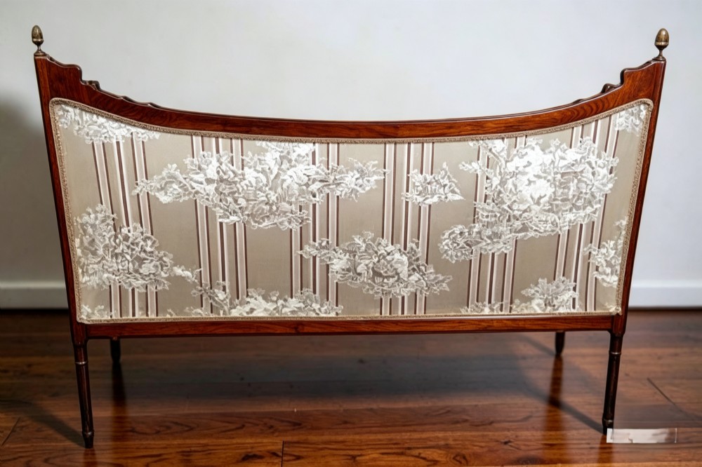 An Edwardian walnut drawing room sofa with a curved backrest, turned finials, slender turned legs, and beige striped floral upholstery. View V