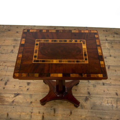 fig 2. A dark brown mahogany side table featuring a rectangular top with geometric timber inlay, a central octagonal column, and a four-pointed pedestal base.