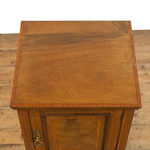 fig 2. An Edwardian mahogany pot cupboard with boxwood inlay, flanked by two matching inlaid side chairs with mustard yellow upholstered seats.