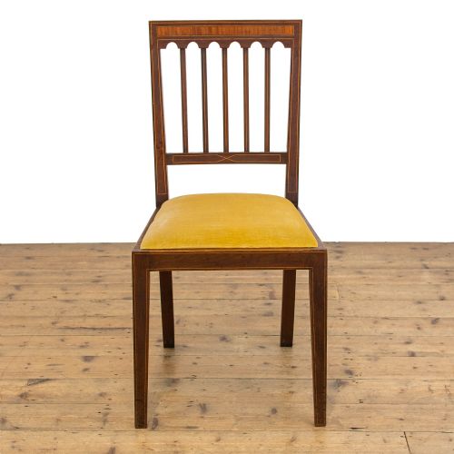 fig 3. An Edwardian mahogany pot cupboard with boxwood inlay, flanked by two matching inlaid side chairs with mustard yellow upholstered seats.