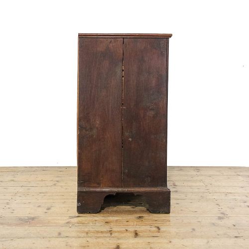 fig 1. A dark mahogany Regency chest of drawers featuring a two-over-three drawer arrangement with oval brass handles and bracket feet.
