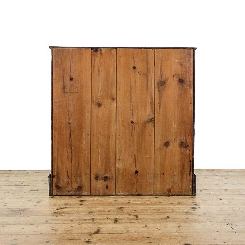 fig 2. A dark mahogany Regency chest of drawers featuring a two-over-three drawer arrangement with oval brass handles and bracket feet.