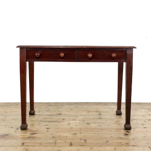 fig 1. An antique Edwardian mahogany writing desk featuring two drawers with wooden knob handles and four square tapered legs.