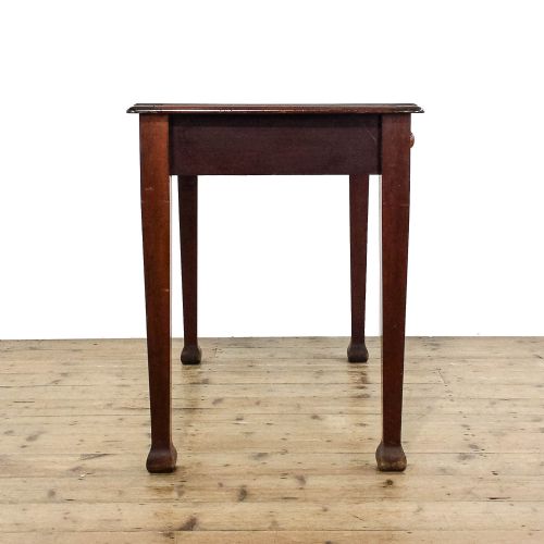 fig 2. An antique Edwardian mahogany writing desk featuring two drawers with wooden knob handles and four square tapered legs.