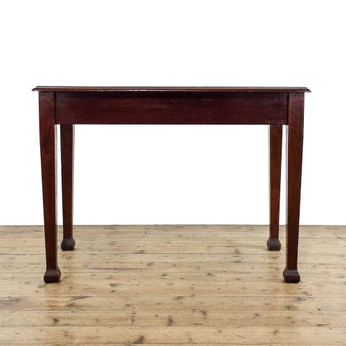 fig 3. An antique Edwardian mahogany writing desk featuring two drawers with wooden knob handles and four square tapered legs.