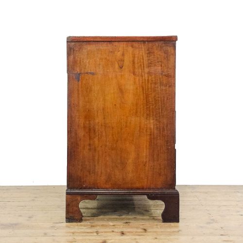 fig 1. An antique 19th-century mahogany chest of drawers featuring two short over three long graduated drawers with brass hardware and bracket feet.