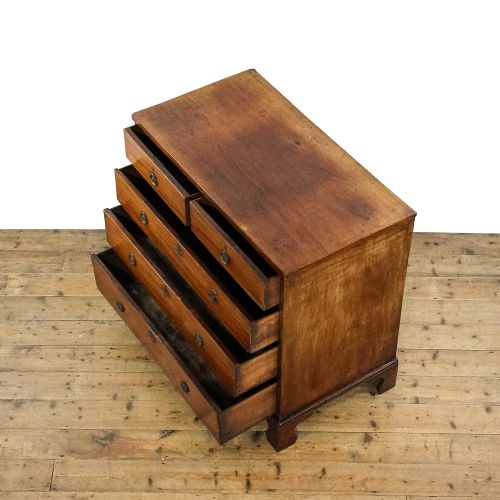 fig 2. An antique 19th-century mahogany chest of drawers featuring two short over three long graduated drawers with brass hardware and bracket feet.