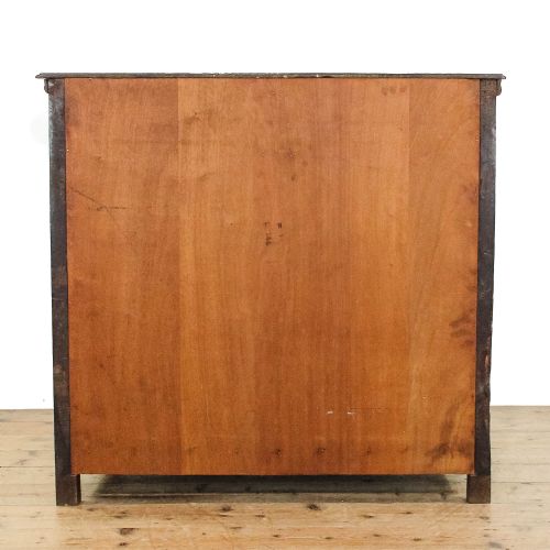 fig 2. An 18th-century walnut chest of drawers featuring geometric moulded drawer fronts, string inlay, and decorative brass teardrop handles.
