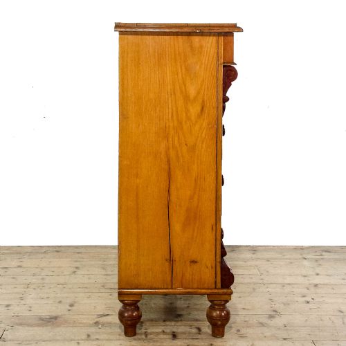 fig 1. A Victorian oak straight-front chest of drawers featuring turned wooden knobs, carved side corbels, and turned feet.