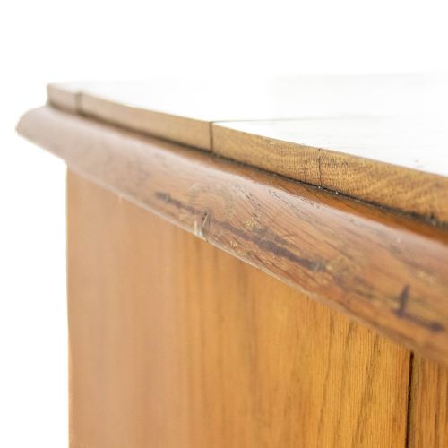 fig 2. A Victorian oak straight-front chest of drawers featuring turned wooden knobs, carved side corbels, and turned feet.