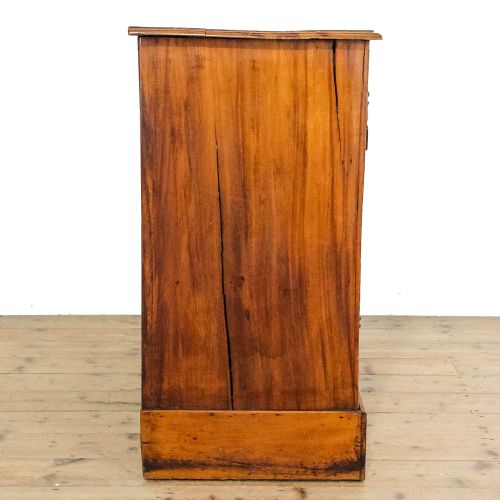 fig 1. An Edwardian satinwood chest of drawers featuring two short over two long reeded drawers with ornate brass handles.