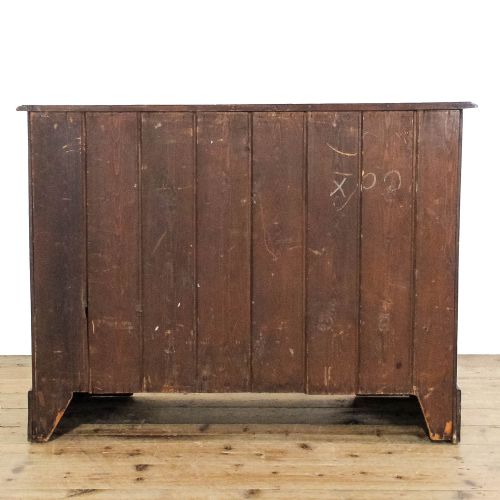 fig 2. An Edwardian satinwood chest of drawers featuring two short over two long reeded drawers with ornate brass handles.