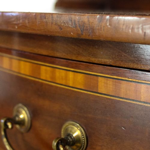 fig 2. An Edwardian mahogany dressing table featuring satinwood marquetry inlay, a central swivel mirror, elevated jewellery drawers, and lower storage drawers with brass drop handles.