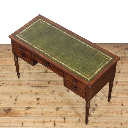 fig 2. An antique dark mahogany writing desk featuring five drawers with turned wooden knobs and slender turned tapering legs.