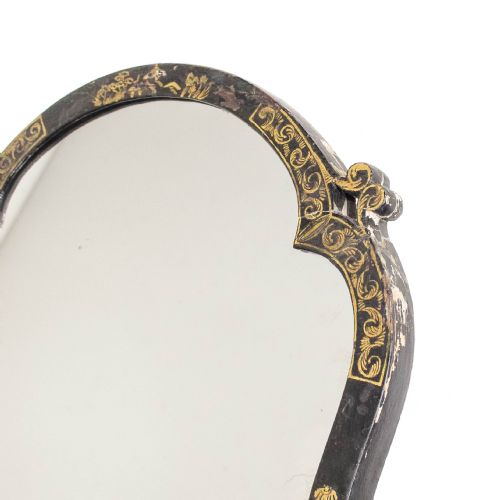 fig 2. An antique ebonised table mirror featuring a scalloped frame decorated with gold hand-painted chinoiserie motifs.