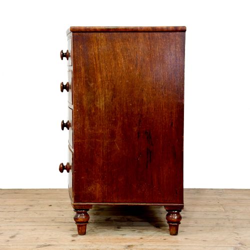 fig 2. An antique mahogany bow front chest of drawers with two short drawers over three long graduated drawers, turned wooden handles, and turned feet.