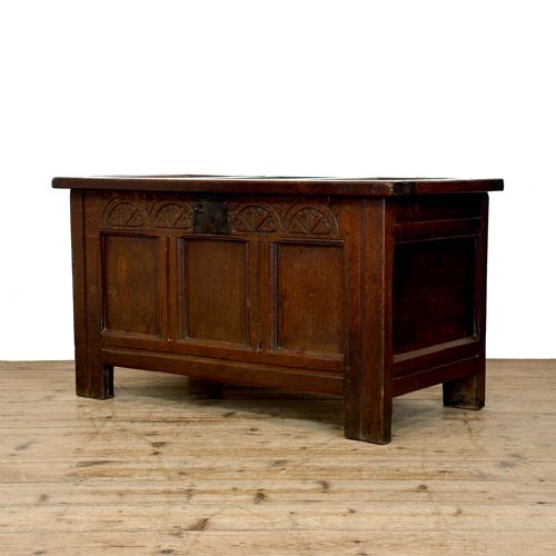 fig 1. A dark oak coffer with three carved lunette frieze panels above recessed lower panels and an iron lock plate.