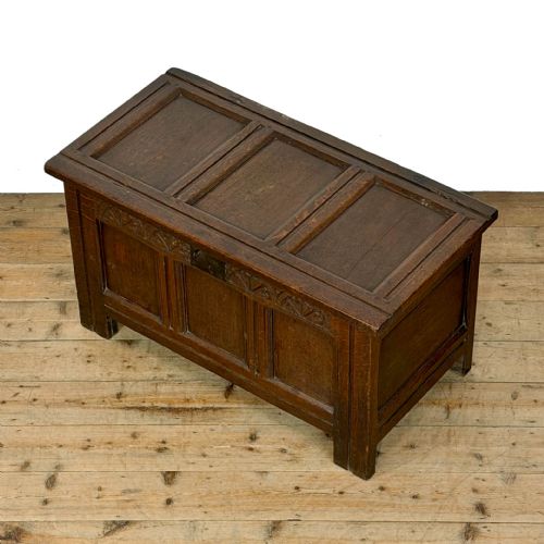 fig 2. A dark oak coffer with three carved lunette frieze panels above recessed lower panels and an iron lock plate.
