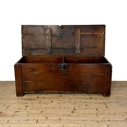 fig 1. A large dark oak coffer featuring the carved initials W A, the date 1647, two small carved crosses, and a central iron lockplate.