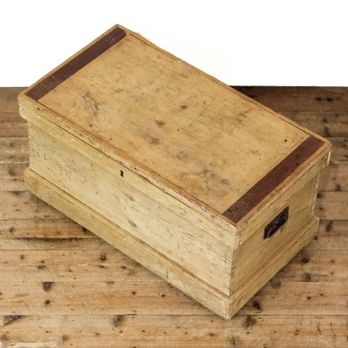 fig 2. A rectangular natural pine storage chest featuring visible hand-cut dovetail joinery, a fitted flat lid, a central keyhole escutcheon, and a thick timber plinth base.