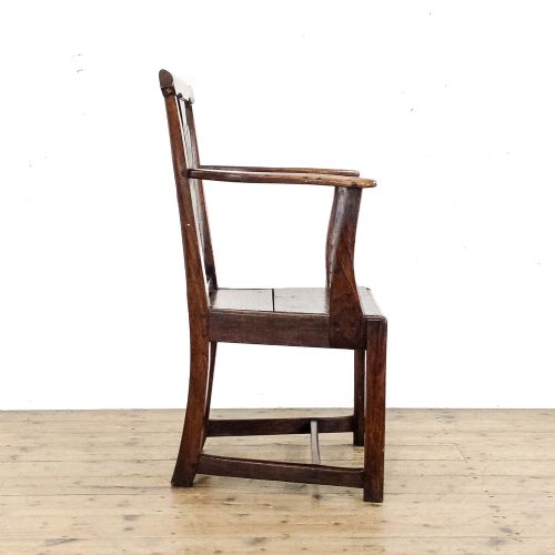 fig 2. A George III period oak open armchair featuring a pierced vase-shaped back splat, swept arms, a solid wooden seat, and square legs joined by stretchers.