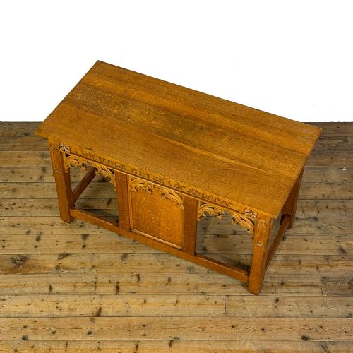 fig 2. A carved oak Gothic Revival chapel altar table featuring trefoil tracery, an inscribed apron in Welsh script, and a solid rectangular top.