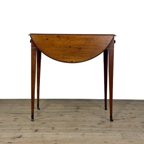 fig 2. A 19th-century mahogany Pembroke table featuring two curved drop leaves, a single drawer with round brass knobs, and four square tapered legs on castors.