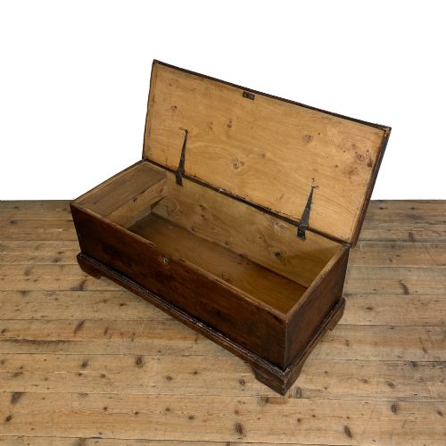 fig 2. A rectangular George III dark elm blanket chest with a hinged lid, brass escutcheon, and bracket feet.