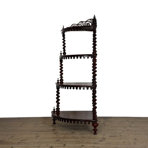 fig 1. A four-tier Victorian mahogany corner whatnot featuring open shelving supported by barley twist columns and topped with a pierced fretwork pediment.