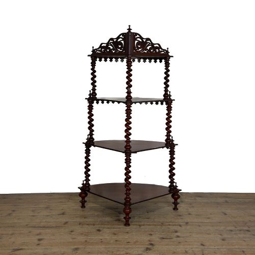 fig 2. A four-tier Victorian mahogany corner whatnot featuring open shelving supported by barley twist columns and topped with a pierced fretwork pediment.