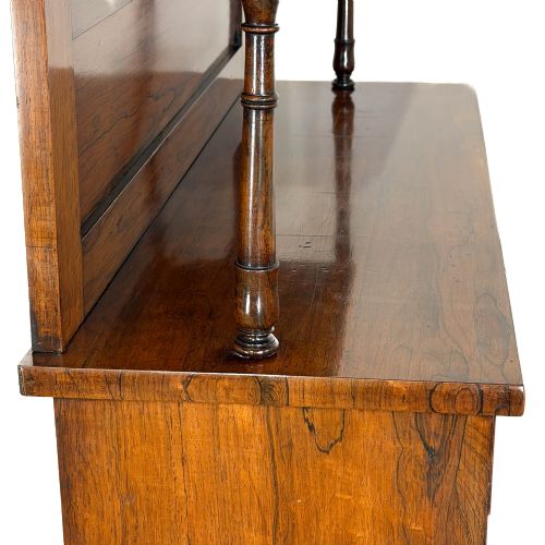 fig 2. An antique rosewood open bookcase featuring a raised back gallery flanked by turned columns, with three open shelves and a beaded trim.