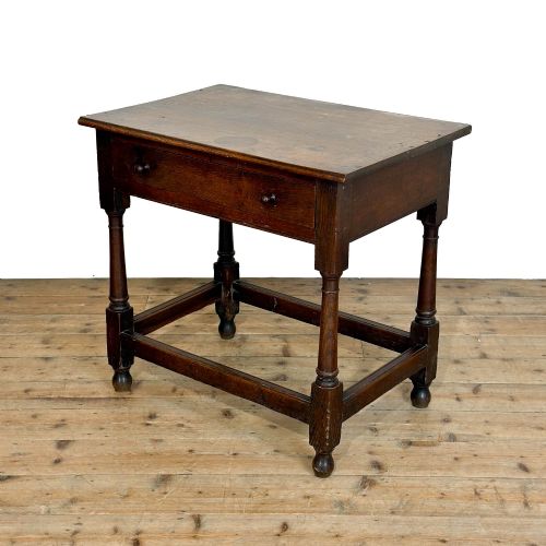 fig 1. An 18th-century dark oak side table featuring a single drawer with turned wooden knobs, turned front legs, and lower stretchers.