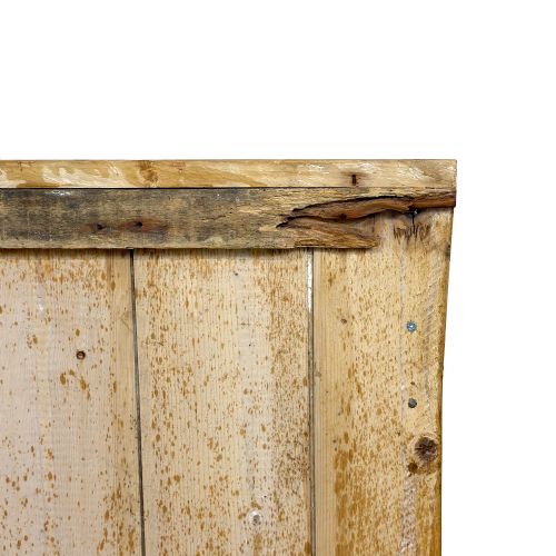 fig 1. An antique pine church pew bench featuring a high vertical plank back, shaped scrolled side arms, a lower foot rail, and a patterned green fabric seat cushion.