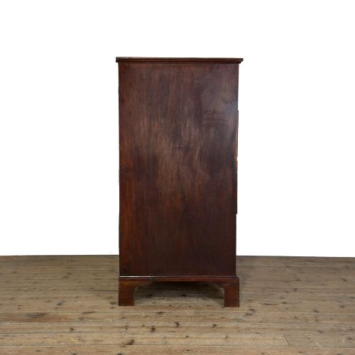 fig 2. A four-drawer Georgian chest of drawers crafted from dark mahogany wood featuring brass swan-neck handles and bracket feet.
