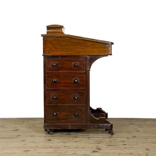 fig 1. An antique Victorian walnut Davenport desk featuring a slanted leather-lined writing surface, an upper stationery compartment, and four drawers on the side.