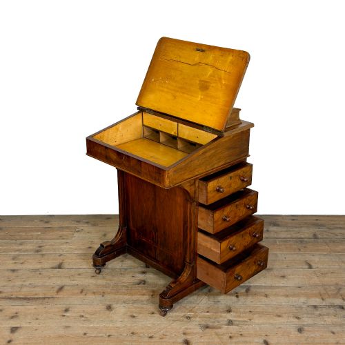 fig 2. An antique Victorian walnut Davenport desk featuring a slanted leather-lined writing surface, an upper stationery compartment, and four drawers on the side.