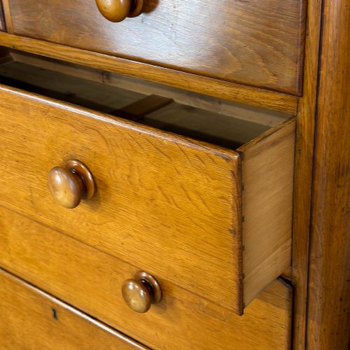 fig 1. A Victorian light oak chest of drawers featuring a two-over-three drawer configuration with turned wooden knobs and turned feet.