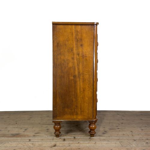fig 2. A Victorian light oak chest of drawers featuring a two-over-three drawer configuration with turned wooden knobs and turned feet.