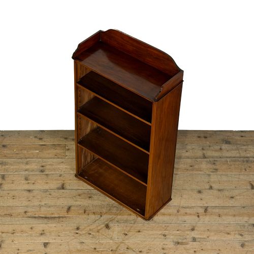 fig 1. A small antique open mahogany bookcase featuring four tiers of shelving and a galleried top upstand.