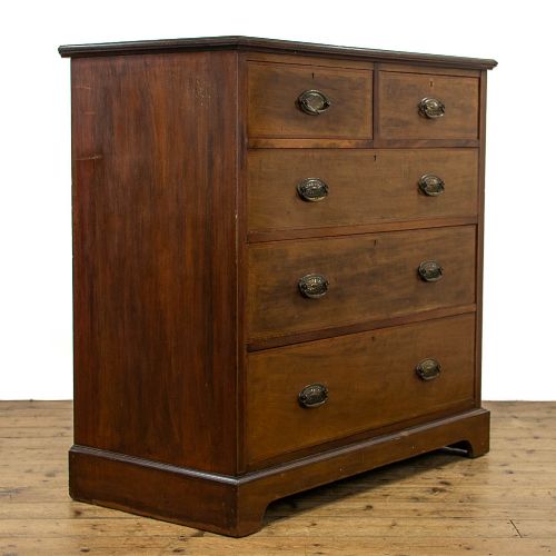 fig 1. An Edwardian mahogany chest of drawers with two short over three long drawers, brass oval drop handles, and fine line inlay detail on a bracket base.