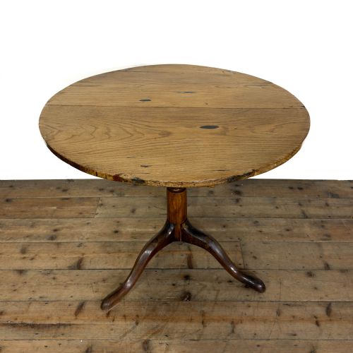fig 1. An antique Georgian light oak tilt-top table with a circular top supported by a central turned column and three splayed tripod legs.