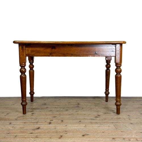 fig 1. A Victorian warm brown pine kitchen table featuring turned legs and a single drawer at one end.