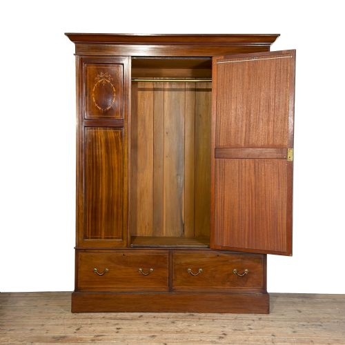 fig 1. An Edwardian mahogany three-door wardrobe with a central oval bevelled mirror, delicate satinwood marquetry panels, and two lower drawers.