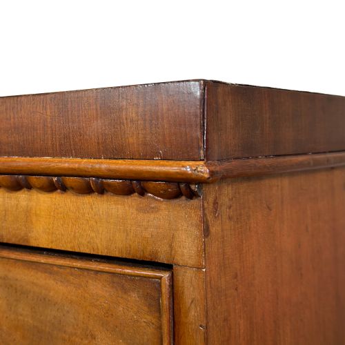 fig 2. A nineteenth-century mahogany bow-front chest of drawers featuring two short over three long graduated drawers with turned knob handles.