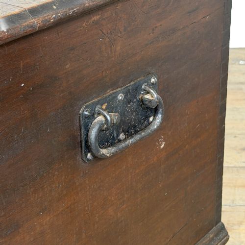 fig 1. A large dark brown oak blanket box featuring a flat hinged lid, visible dovetail joinery, side drop handles, and a central keyhole.