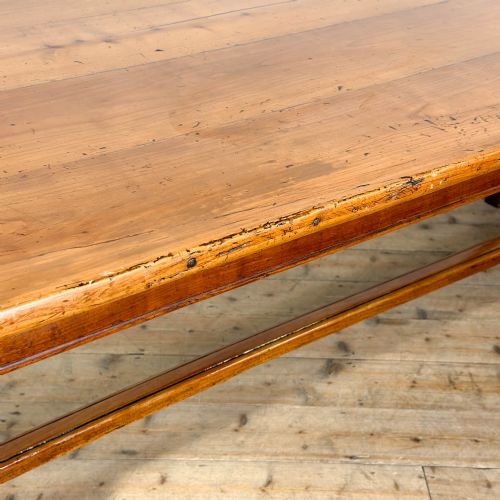 fig 2. An antique fruitwood refectory dining table featuring a rectangular plank top, an extended slide-out leaf, square legs, and lower H-stretchers.
