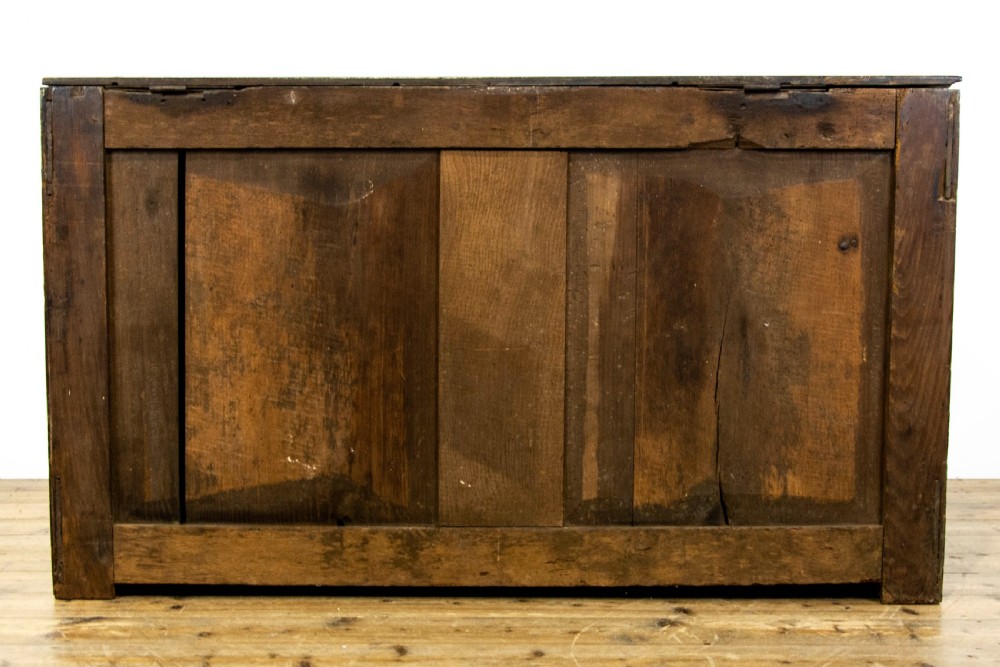 An eighteenth-century Welsh oak coffer featuring three arched raised front panels and a central brass keyhole escutcheon. View VIII