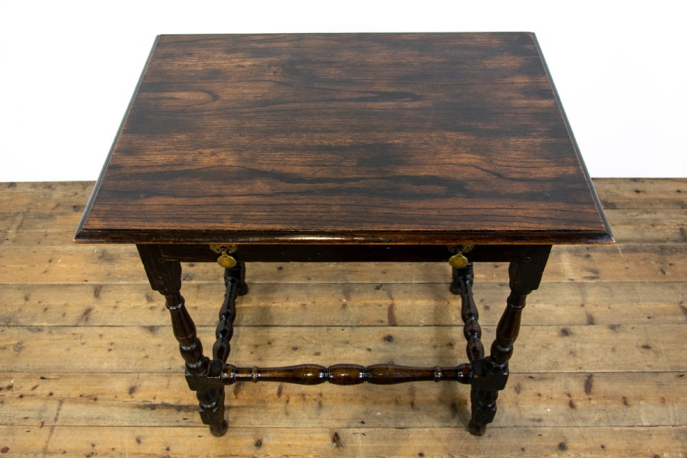 A dark elm side table featuring turned legs, horizontal turned stretchers, and a single drawer with brass drop handles. View IV